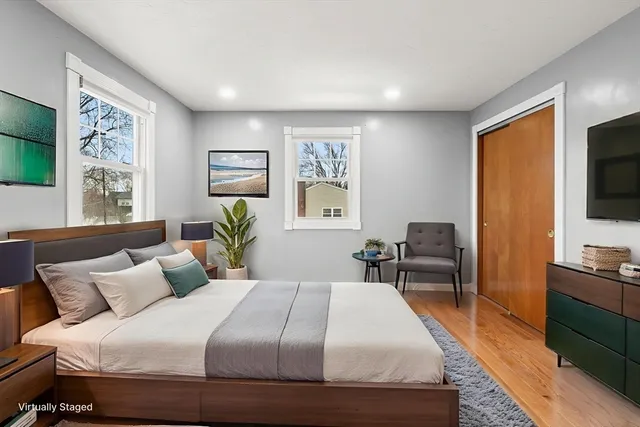 a bedroom with a bed and a flat screen tv