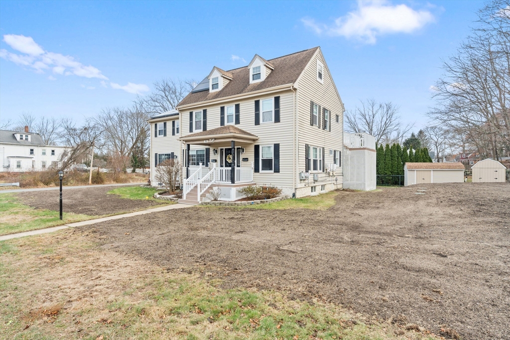 70 West High Street, Unit 2 Avon, MA 02322 - Photo 2 of 22 a view of a white house with a yard
