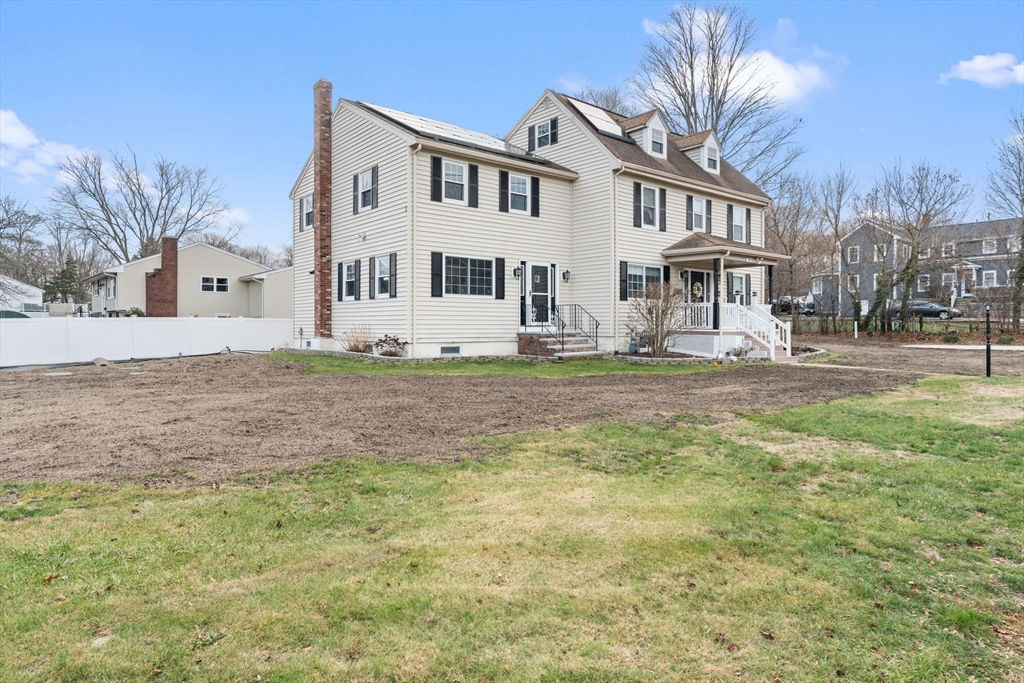 70 West High Street, Unit 2 Avon, MA 02322 - Photo 22 of 22 a view of a white house next to a yard with large trees