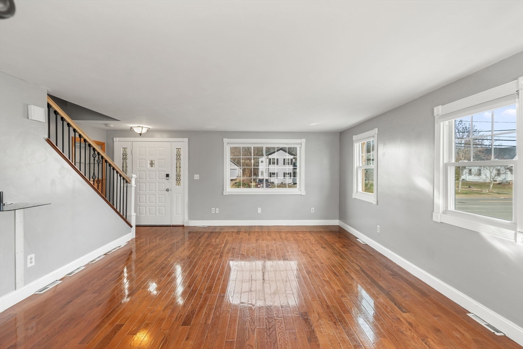 70 West High Street, Unit 2 Avon, MA 02322 - Photo 6 of 22 a view of an empty room with wooden floor and a window