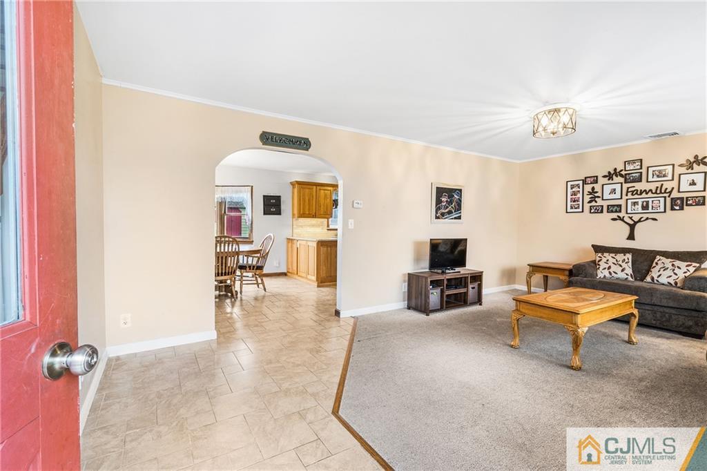 151 East Cliff Road Colonia, NJ 07067 - Photo 6 of 29 a living room with furniture and a flat screen tv