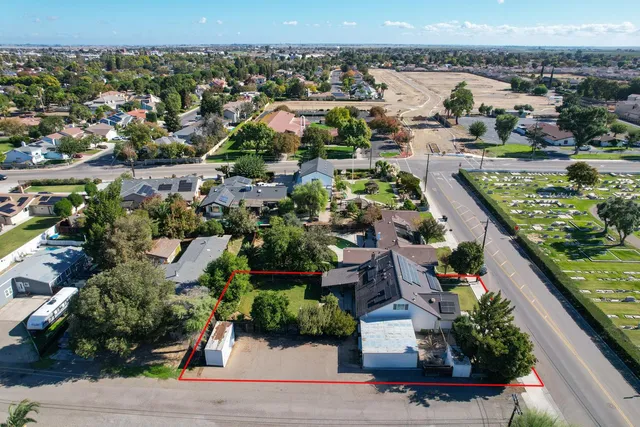 an aerial view of residential houses with outdoor space and swimming pool