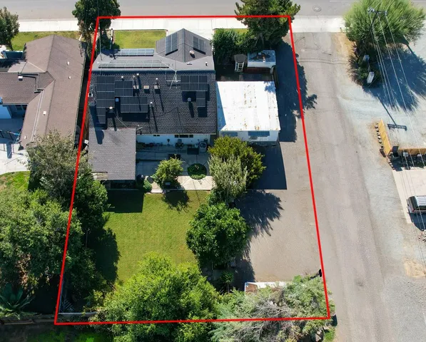 an aerial view of a house with a yard and garden