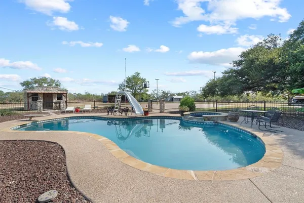 a view of a swimming pool with a lounge chair