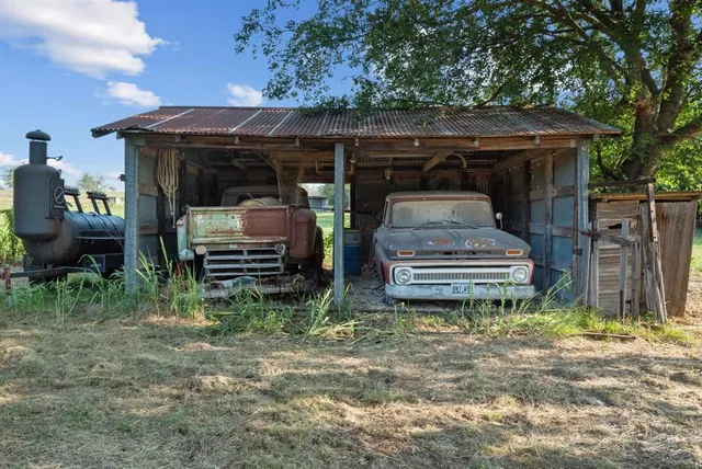 a view of backyard and wooden fence