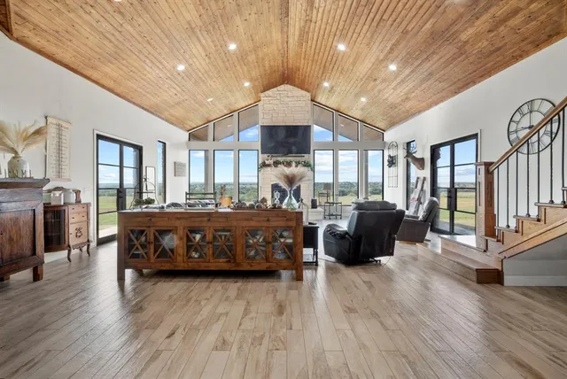 a living room with a bed furniture and a wooden floor