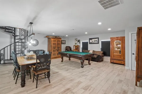 a living room with furniture a rug and white walls
