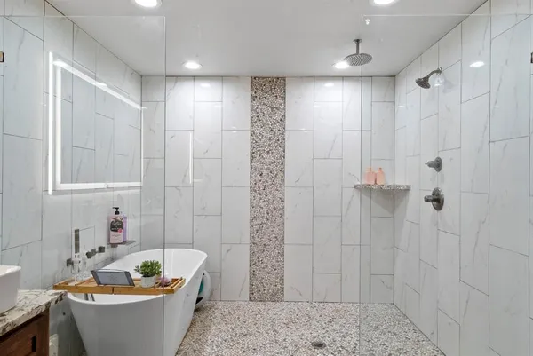 a bathroom with a bathtub and shower