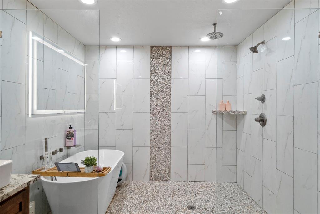 2296 County Road 290 Dublin, TX 76446 - Photo 8 of 40 a bathroom with a bathtub and shower