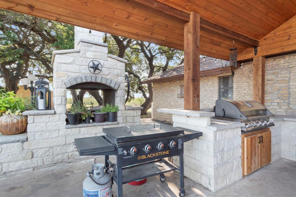 2296 County Road 290 Dublin, TX 76446 - Photo 10 of 40 a view of a patio with table and chairs and potted plants