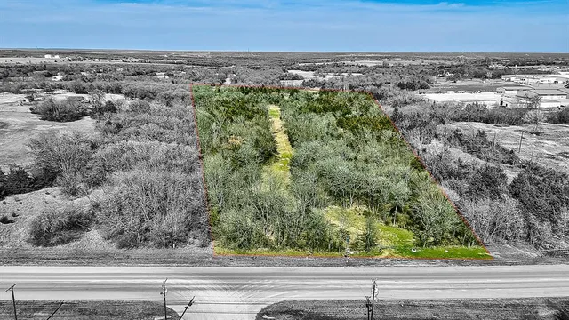 an aerial view of a city view and mountain view in back