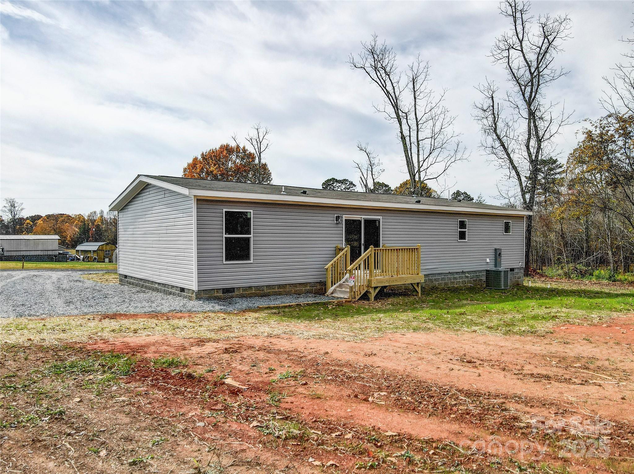 516 Lake Mullis Road Harmony, NC 28634 - Photo 24 of 28 a view of a house with backyard and trees