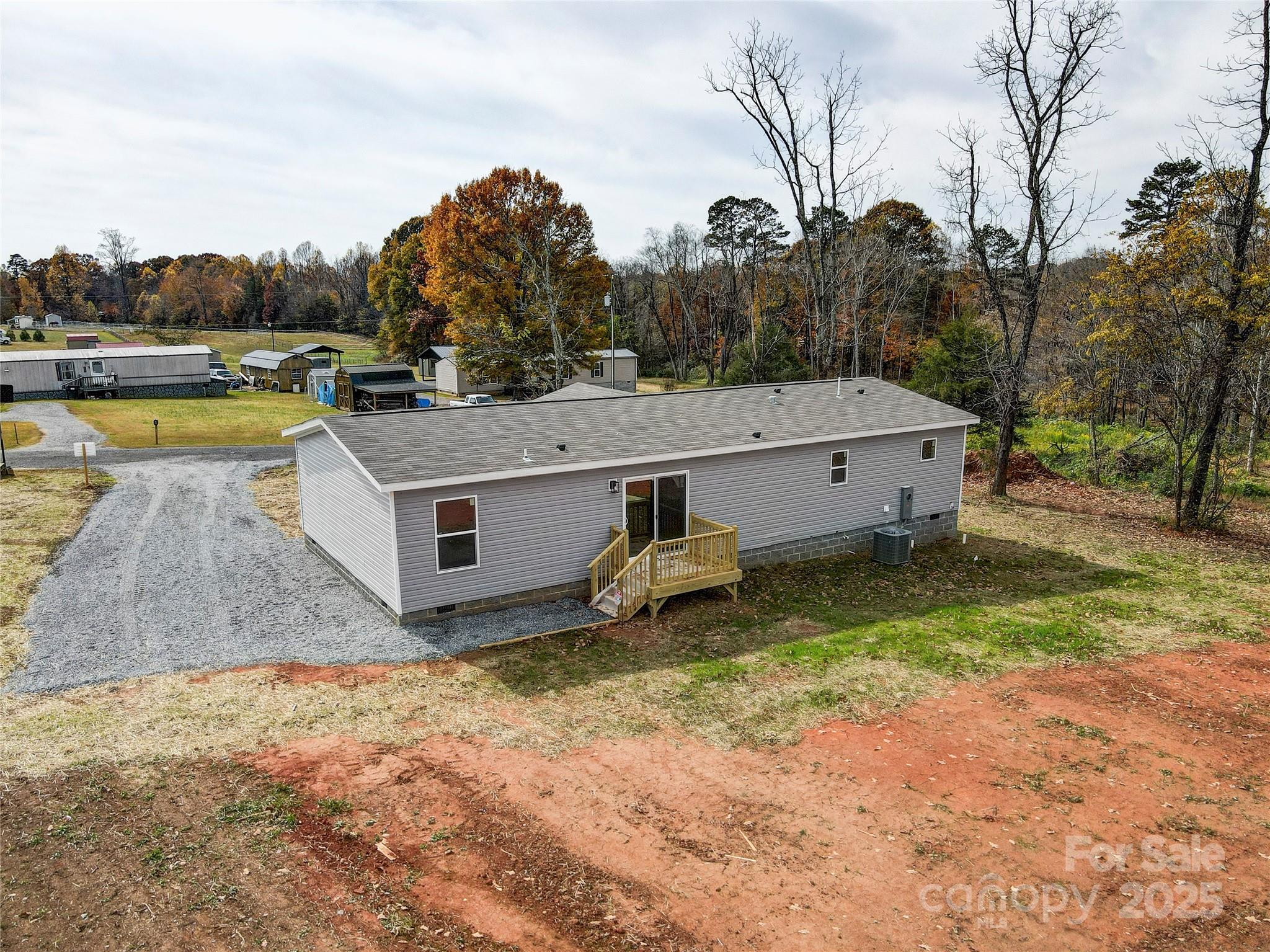 516 Lake Mullis Road Harmony, NC 28634 - Photo 26 of 28 a view of a house with pool and a yard