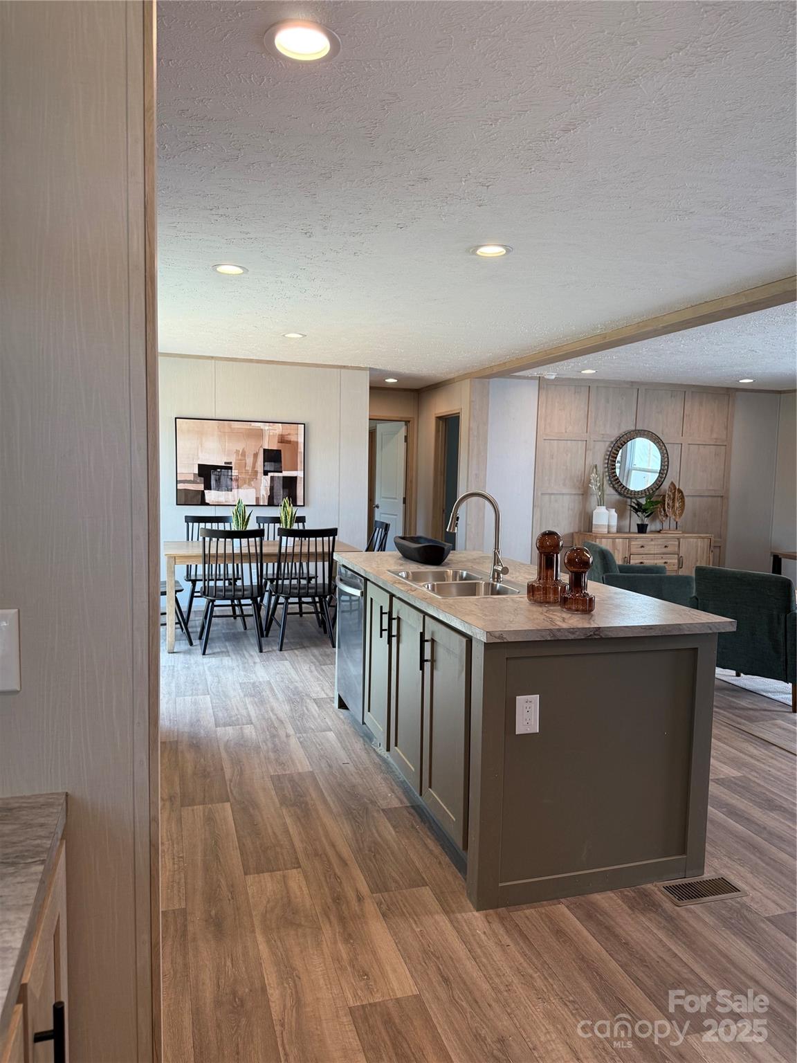 516 Lake Mullis Road Harmony, NC 28634 - Photo 8 of 28 a kitchen with stainless steel appliances granite countertop a stove and a wooden floors