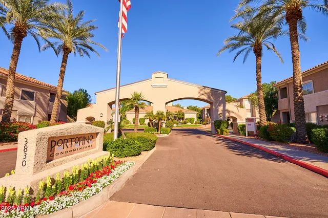 a street sign on a sidewalk next to a road