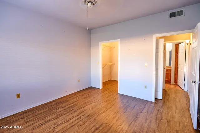 an empty room with wooden floor and door