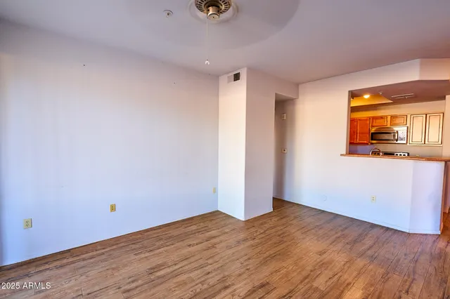 a view of a room with wooden floor and a window
