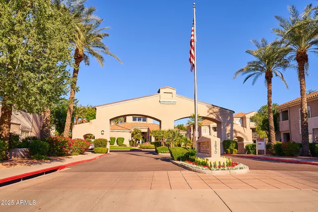 a view of a city street lined with buildings and trees