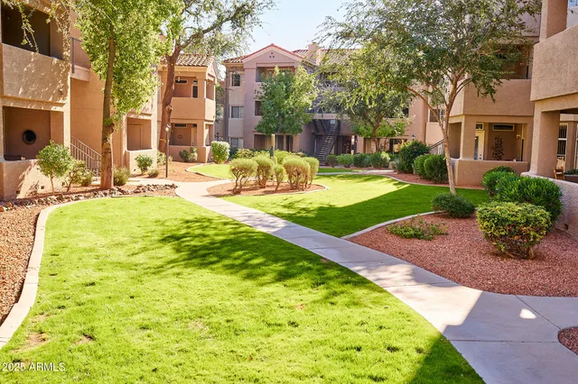 a front view of a house with a yard and outdoor seating