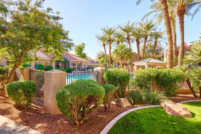 a view of a swimming pool with a bench and some trees