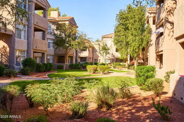 a view of a house with a big yard and large trees