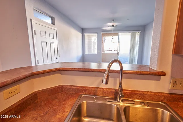 a view of a kitchen with a sink and a window