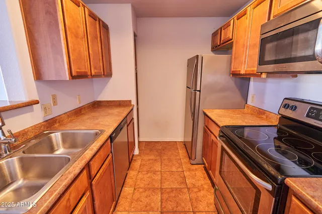 a kitchen with a sink and a stove top oven