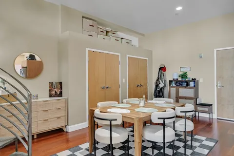 a view of a dining room with furniture and wooden floor