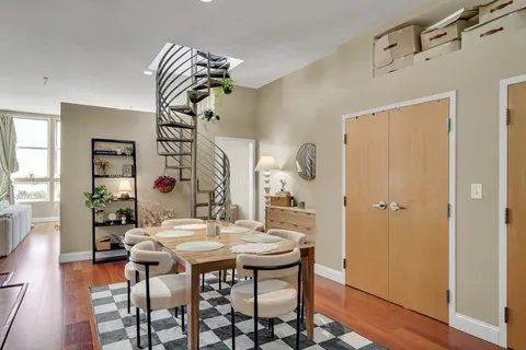 a dining room with furniture and window