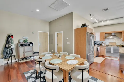 a view of a dining room with furniture and wooden floor