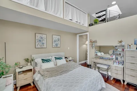 a bedroom with a bed and a chandelier