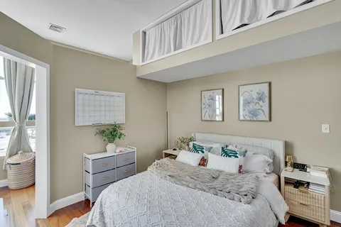 a bedroom with a bed and a window