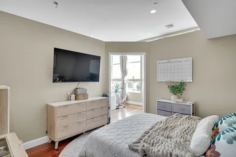 a bedroom with a bed and a flat screen tv