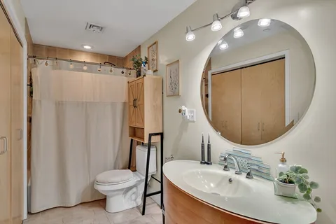 a bathroom with a sink toilet and shower