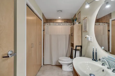 a bathroom with a sink toilet and shower