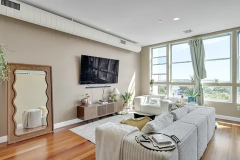 a bedroom with furniture and a flat screen tv