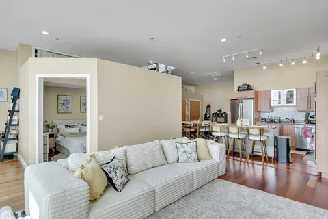 a living room with furniture and wooden floor