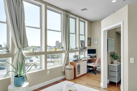 a living room with furniture and a floor to ceiling window