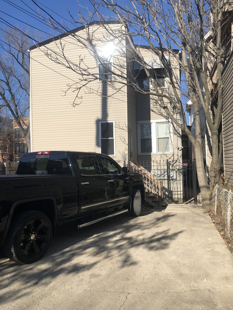 2907 West Lyndale Street, Unit 2R Chicago, IL 60647 - Photo 11 of 11 a car parked in front of a house