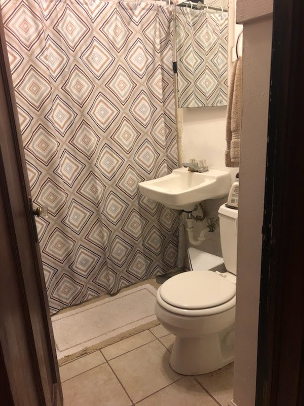 2907 West Lyndale Street, Unit 2R Chicago, IL 60647 - Photo 9 of 11 a white toilet sitting next to a white cabinet