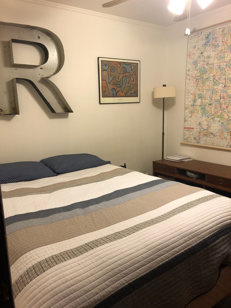 2907 West Lyndale Street, Unit 2R Chicago, IL 60647 - Photo 10 of 11 a bedroom with a bed and a painting on the wall