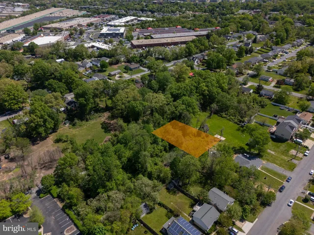 an aerial view of a house with a yard and lake view