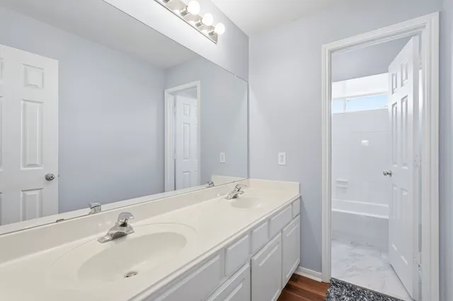 a spacious bathroom with a shower sink and mirror