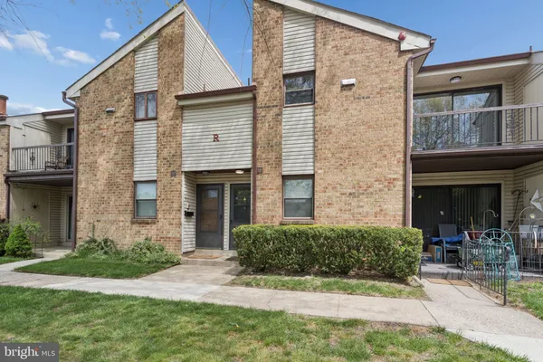 a view of a house with brick walls