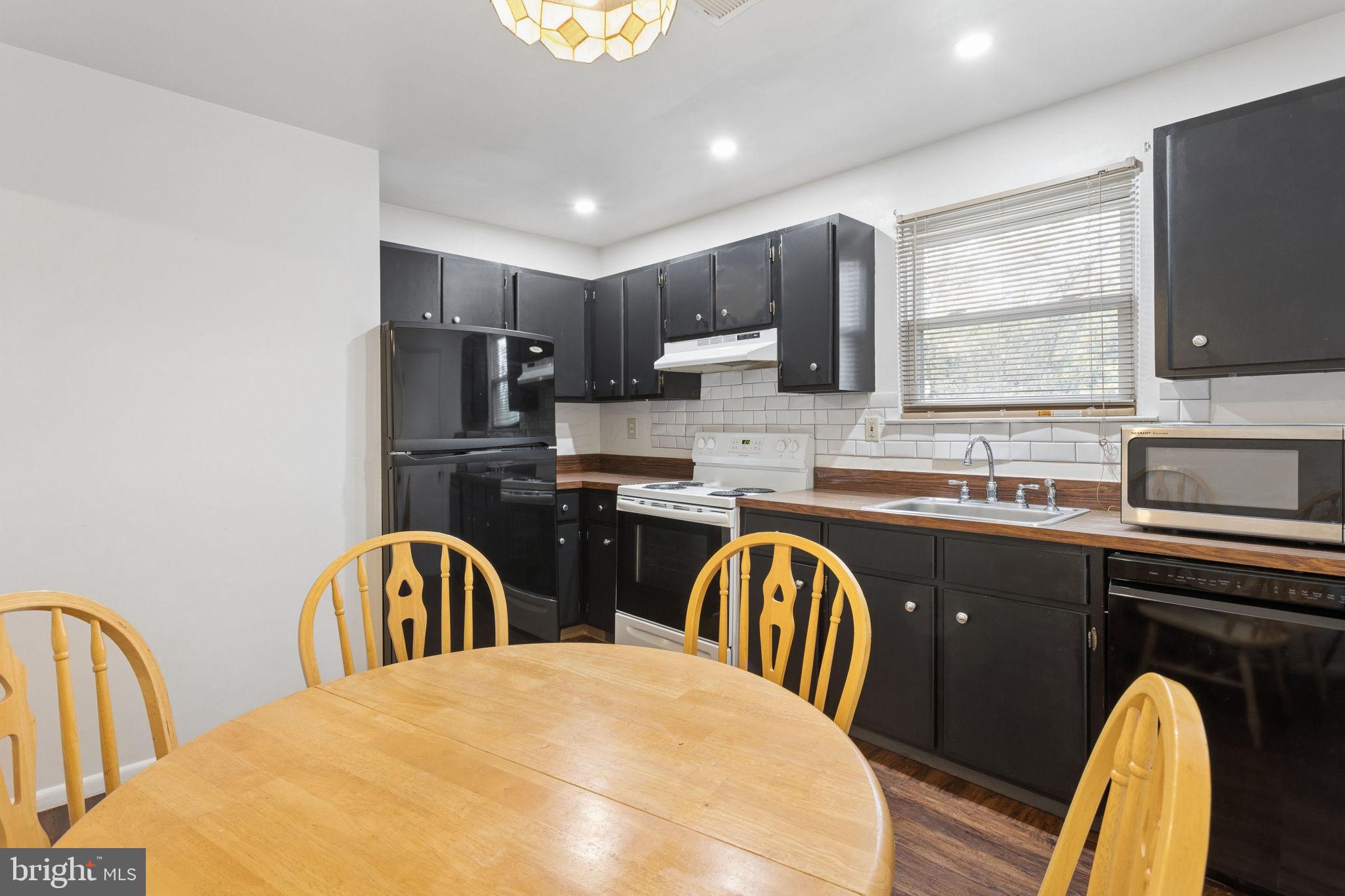 1475 Mt Holly Road, Unit R3 Edgewater Park, NJ 08010 - Photo 12 of 19 a kitchen with stainless steel appliances granite countertop a sink a stove a dining table and chairs