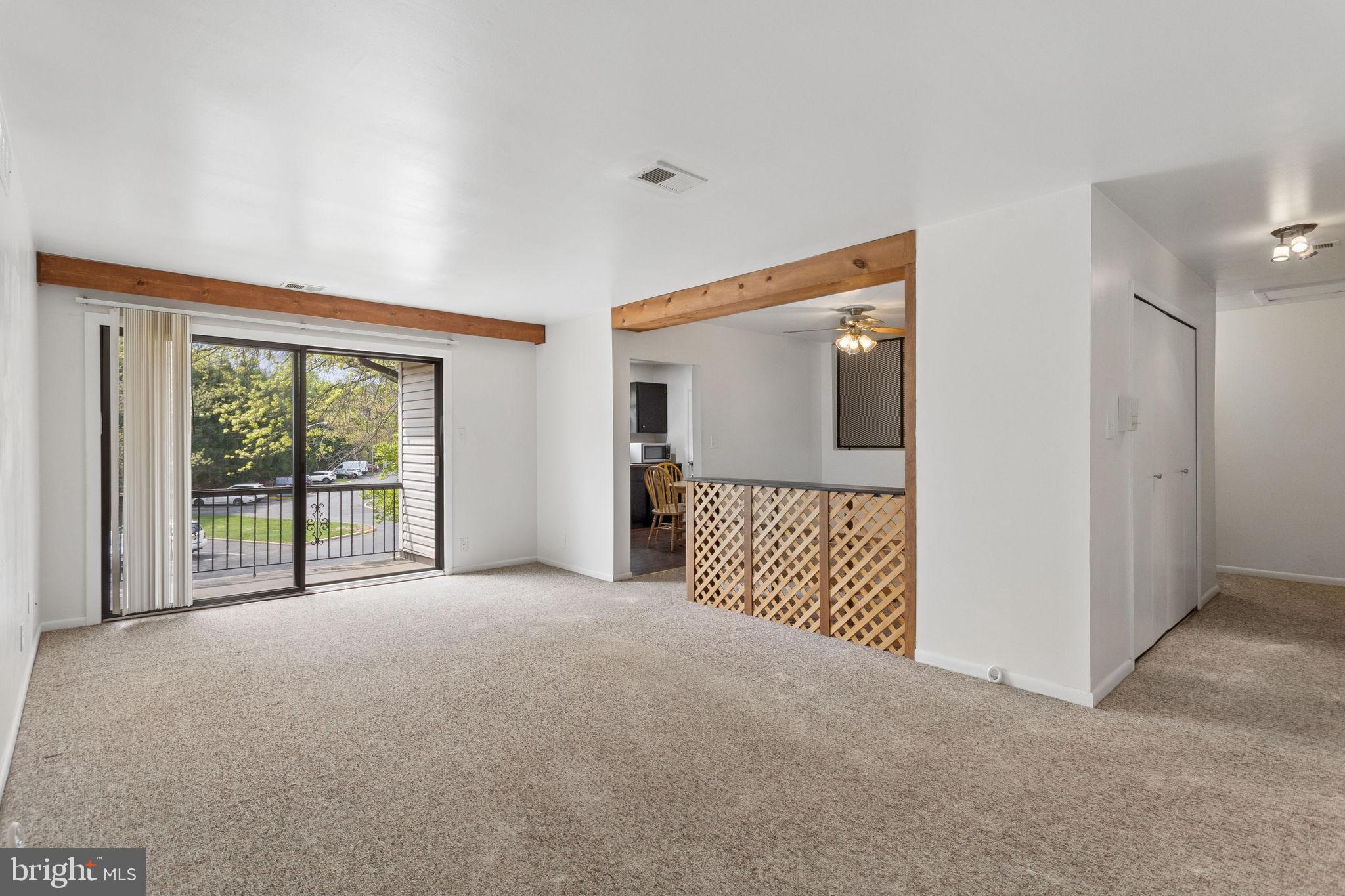1475 Mt Holly Road, Unit R3 Edgewater Park, NJ 08010 - Photo 6 of 19 a view of a room with large windows and a ceiling fan