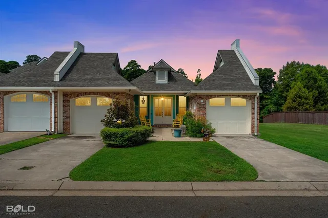 a front view of a house with a garden and plants