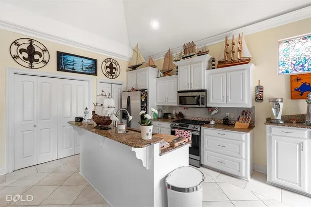 a kitchen with stainless steel appliances granite countertop a sink and cabinets