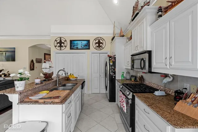a kitchen that has a lot of cabinets in it