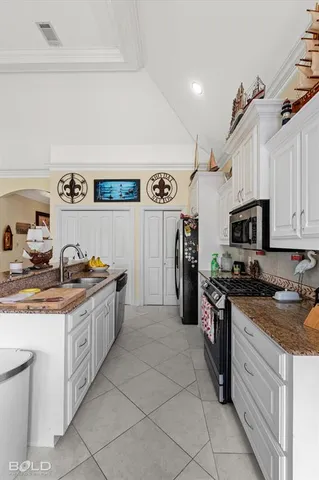 a kitchen with granite countertop a sink and cabinets